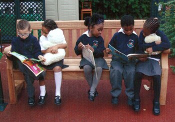 Children reading on the Viv Jones bench