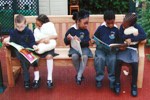 Children reading on bench